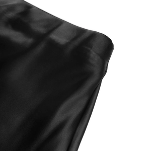 Detailed macro view showing the smooth texture and silky luster of the black satin fabric