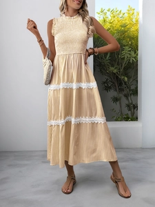 Detail of lace trim and striped fabric on a sleeveless French style summer midi dress
