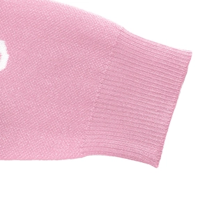 Close-up of pink knit sweater cuff featuring detailed ribbed texture and soft fabric