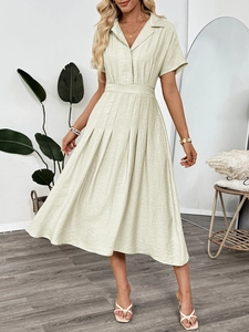 Close-up of light beige short sleeve shirt dress with pleated skirt and natural texture