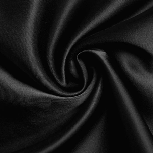 Detail of high-gloss black satin fabric with smooth texture and elegant drape effect