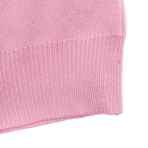 Detail shot of the elastic ribbed hem and fine knit texture of this pink sweater