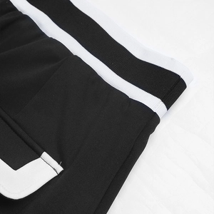 Detail of high waist straight skirt with black and white striped ribbed waistband