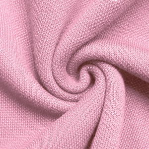 Close-up of pink bow jacquard knit fabric showing soft texture and fine weave details