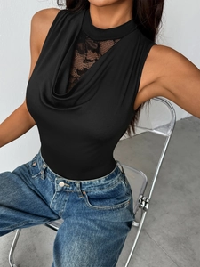 Detail of elegant black sleeveless bodysuit featuring lace patchwork and draped cowl neck