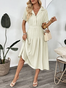 Detail of sage green midi dress with waist pleats and classic lapel collar