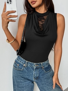 Detail of elegant black lace patchwork and draped neckline on a sleeveless bodysuit top