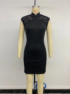 Detail of black qipao dress with intricate floral embroidery and lace patchwork