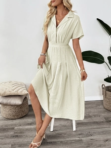 Detail of short sleeve shirt dress with pleated skirt in light beige linen fabric