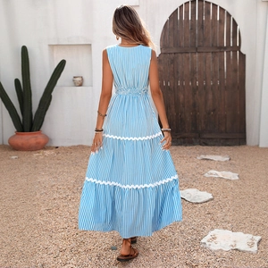 Back view of blue striped sleeveless maxi dress with white ric-rac trim and tiered skirt