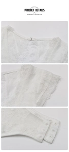 Detailed macro view of white lace bodysuit featuring metal hooks and snap closure