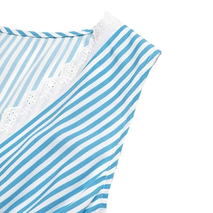 Detail of V-neckline with white lace embroidery and blue striped fabric texture