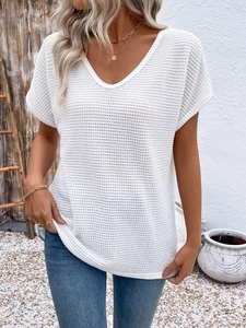 Detail of white V-neck top with waffle texture fabric and casual lace splicing details