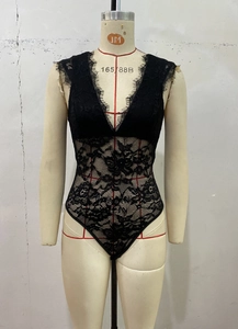 Detailed view of black lace bodysuit featuring deep V-neck and sheer floral patterns