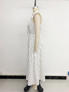 Détail d'une robe midi vintage sans manches à pois avec revers et coupe à la taille