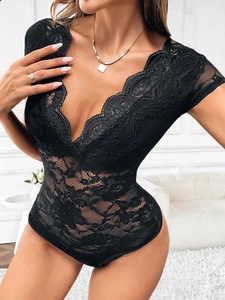 Detail of black lace bodysuit with deep V-neckline and intricate floral embroidery