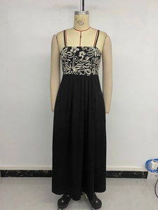 Détail du corsage en patchwork floral et de la jupe longue noire fluide à taille haute