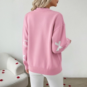 Chic pink bow jacquard knit sweater for women featuring a loose fit and festive style