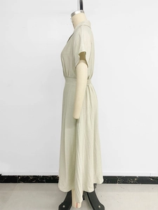 Detail view of sage green shirt dress showing the elastic waist and A-line silhouette