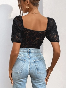 Close-up back view of elegant black lace bodysuit with square neckline and floral patterns