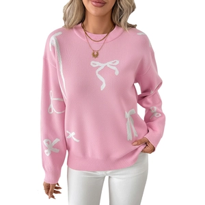 Women's pink crewneck knit sweater with white bow jacquard patterns in a soft texture