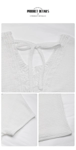 Close-up of white waffle knit texture and delicate lace neckline with tie bow detail