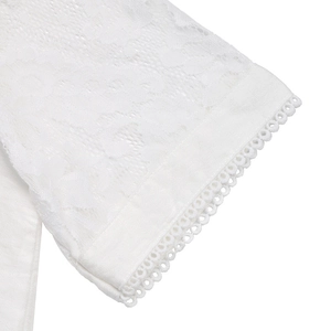 Detail of white lace sleeve featuring delicate floral embroidery and cutout patterns