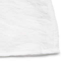 Detailed macro view of white cotton linen fabric with natural texture and hem stitching