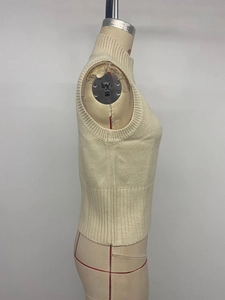 Detail view of a slim-fit beige sleeveless knit vest featuring a refined high collar design