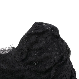 Close-up of black floral lace fabric with delicate eyelash trim on sleeve details