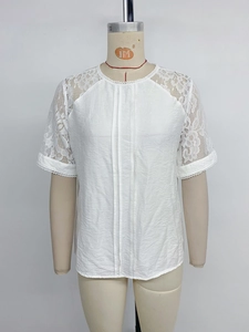 Detailed view of the white lace patchwork and vertical pleats on the women's round neck blouse