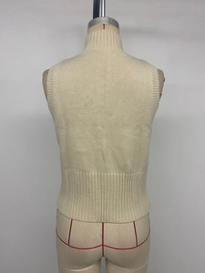 Rear view of a beige slim-fit sleeveless knit cardigan with ribbed hem on a mannequin
