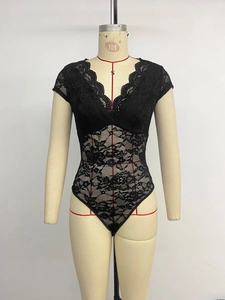 Close-up of black lace bodysuit featuring a deep V-neckline with scalloped floral edges