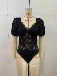 Detail of black lace bodysuit with puff sleeves and corset-style boning structure
