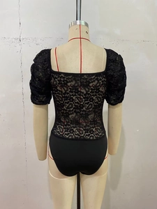 Rear view of black lace bodysuit featuring floral patterns and puff sleeves on mannequin
