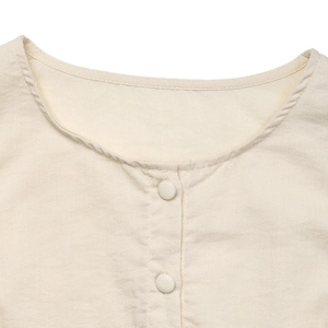 Detail of round neckline with fabric covered buttons on beige linen sleeveless dress