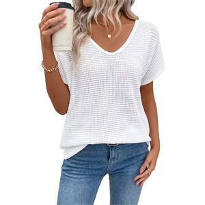 Women's white V-neck waffle knit short sleeve top paired with blue jeans in a casual style