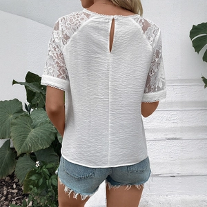 Back view of a white short sleeve blouse featuring delicate lace stitching and teardrop cutout