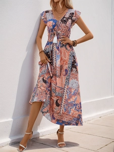 Close-up of bohemian paisley floral print dress with deep V-neck and tassel drawstrings
