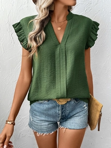 Detail of dark green V-neck top showing textured fabric and ruffle flutter sleeves