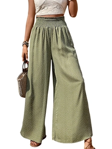 Detail of high waist elastic smocked waistband on green polka dot wide leg summer trousers
