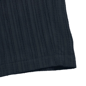 Macro shot of dark blue jumpsuits textured fabric showing vertical seersucker ribbing details
