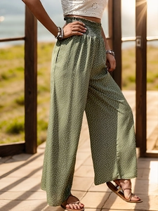 Close-up of olive green wide-leg pants featuring white polka dots and high elastic waist
