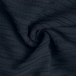 Close-up of navy blue textured fabric showing horizontal ribbed patterns and soft material