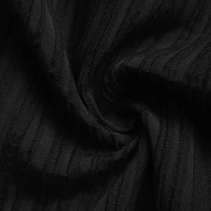 Macro view of black vertical texture fabric showing knitting detail and premium fiber finish