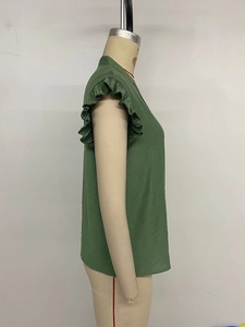 Detailed view of dark green V-neck sleeveless blouse with ruffled flutter sleeve edges
