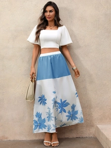 Detail of white square neck puff sleeve crop top with blue floral print maxi skirt