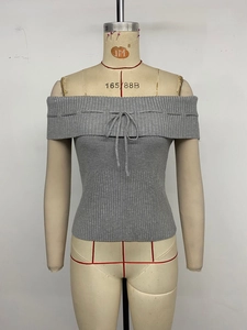 Detailed view of grey off-shoulder ribbed knit top with a dainty bow tie detail