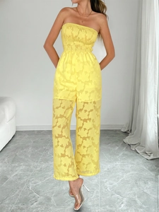 Détail d'une combinaison bustier jaune avec jacquard floral et jambes larges fluides