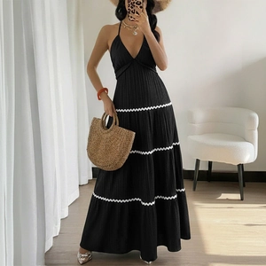Elegant black halter maxi dress with V-neck, pleated texture and white wavy lace trim